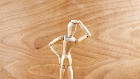 figurine standing with hand on head