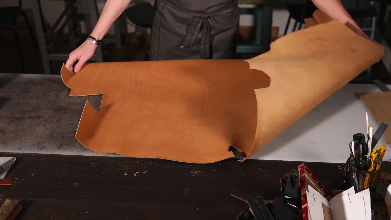 Leatherworker Handling Leather in a Workshop