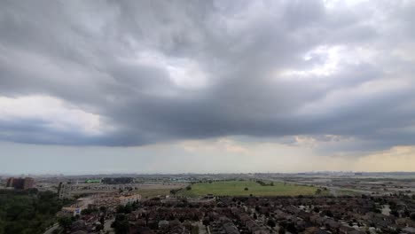 looking out from a highrise apartment panning across dark threatening stormy skies