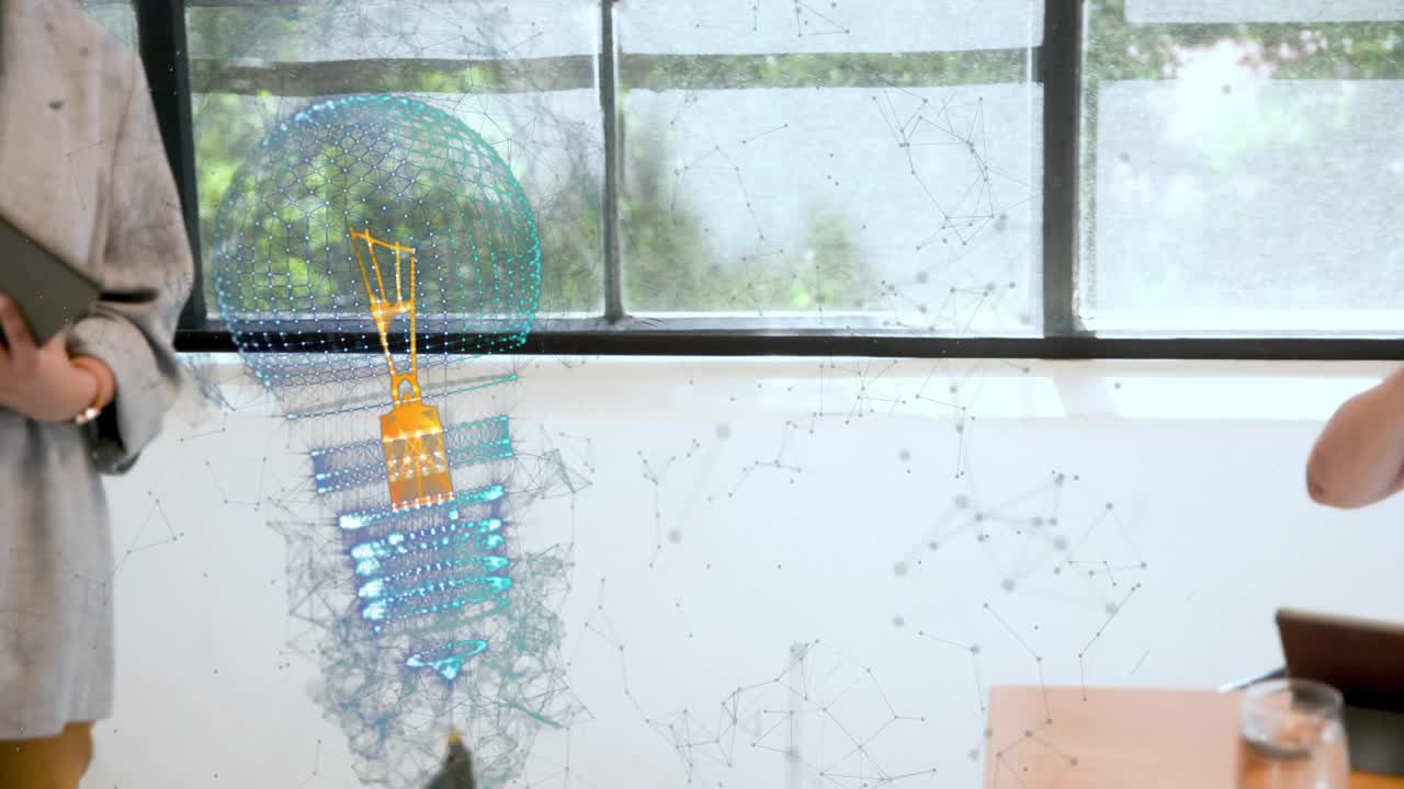 Female presenter tapping tablet and guiding holographic lightbulb down wall during business demo