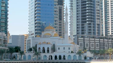 beautiful traditional mosque in dubai near modern skyscrapers