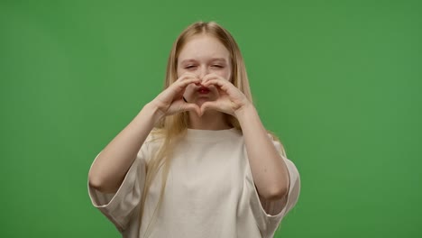 girl making heart shape with hands