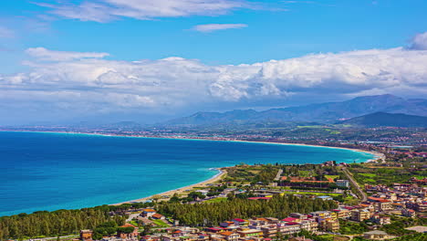 View-of-a-beachside-town-in-Sicily-with-Etna-volcano-in-the-background