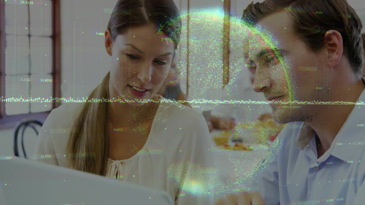 Pointing blue-shirted man and beige-blouse woman leaning over laptop at cafe, showing waveform