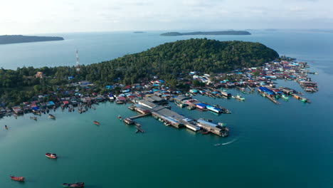 aerial drone footage moving from right to left over a fisherman floating village in king island, cambodia