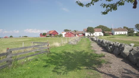 scandinavian countryside nordic houses on farm field, walking point of view