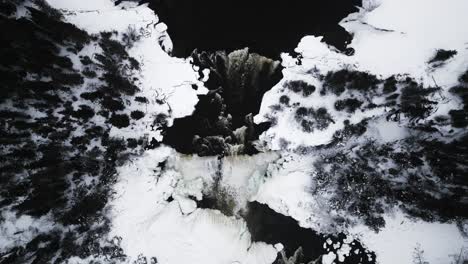 overhead establishing close up 4k drone shot frozen winter tourism landmark pisew kwasitchewan waterfall provincial park thompson manitoba northern arctic canada