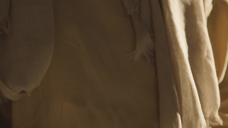 Close Up Of Man Wearing Robes Representing Figure Of Jesus Christ With Hands Clasped Together