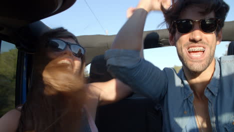 Three-excited-friends-in-the-back-of-a-car-on-a-road-trip