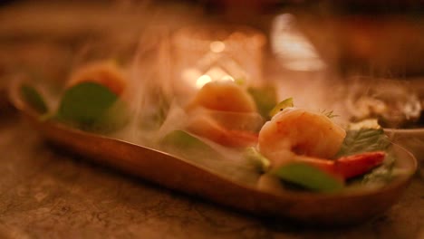 a steaming shrimp dish with vibrant vegetables under warm candlelight, creating an inviting and cozy atmosphere