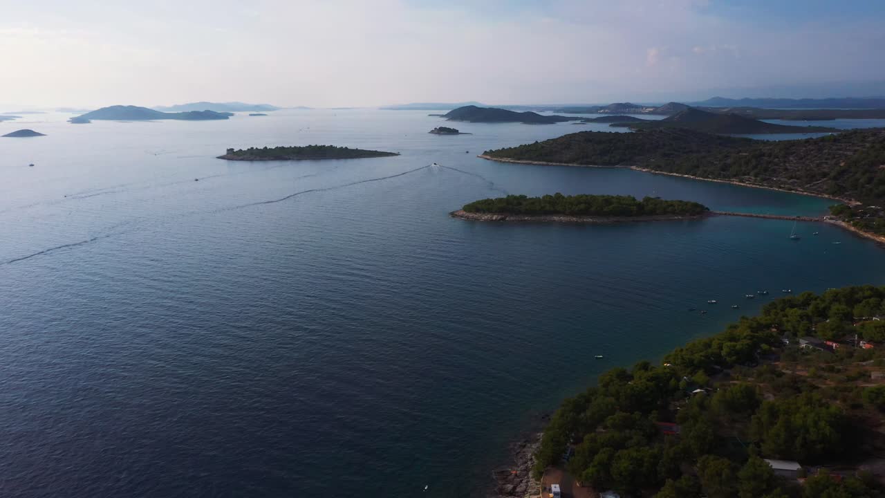 Amazing aerial view panning up revealing coastline of Dalmatia, Croatia filmed in 4k with clear water, beaches and rocky shore of the Adriatic Sea