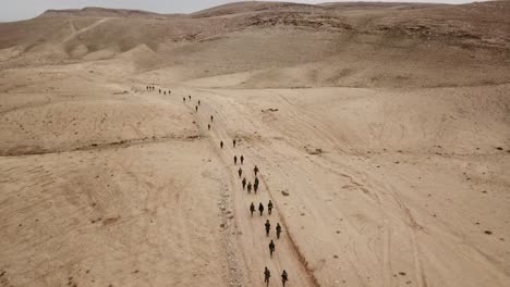 drone shot of soldier walking hand in hand during routine physical training