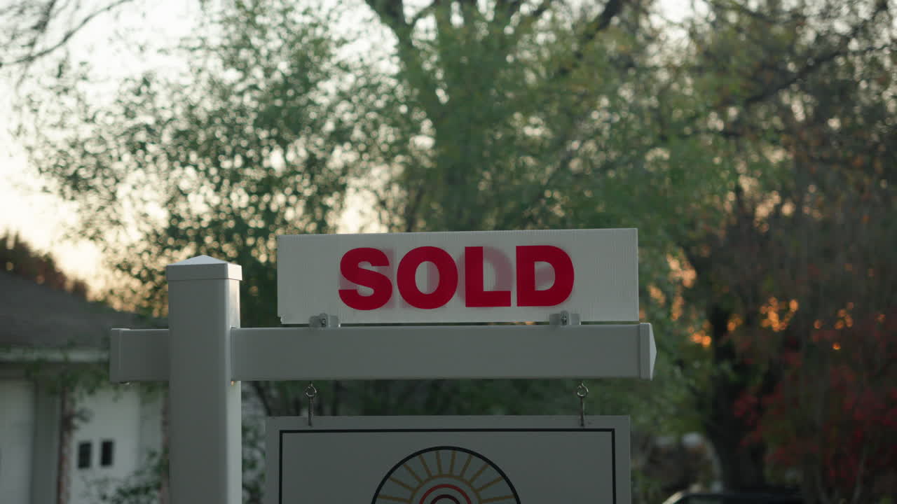 House for sale sold sign outside of real estate property