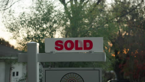 house for sale sold sign outside of real estate property