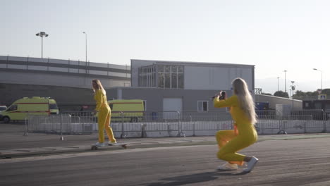 two women in yellow outfits skateboarding