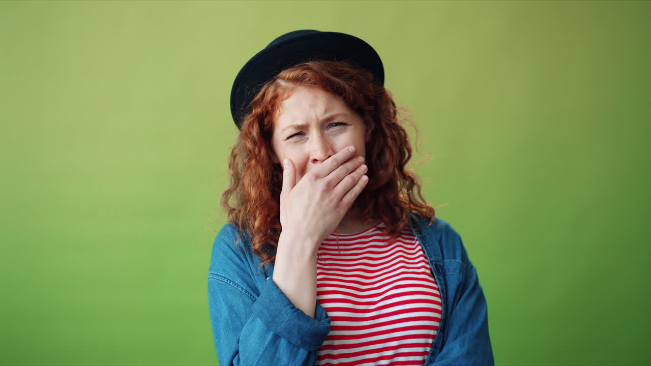 Woman with Red Hair and a Hat Looking Bored