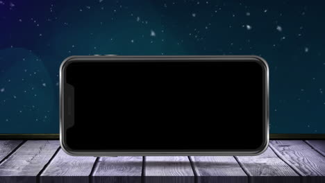 animation of blank smartphone screen on wooden surface over winter scenery