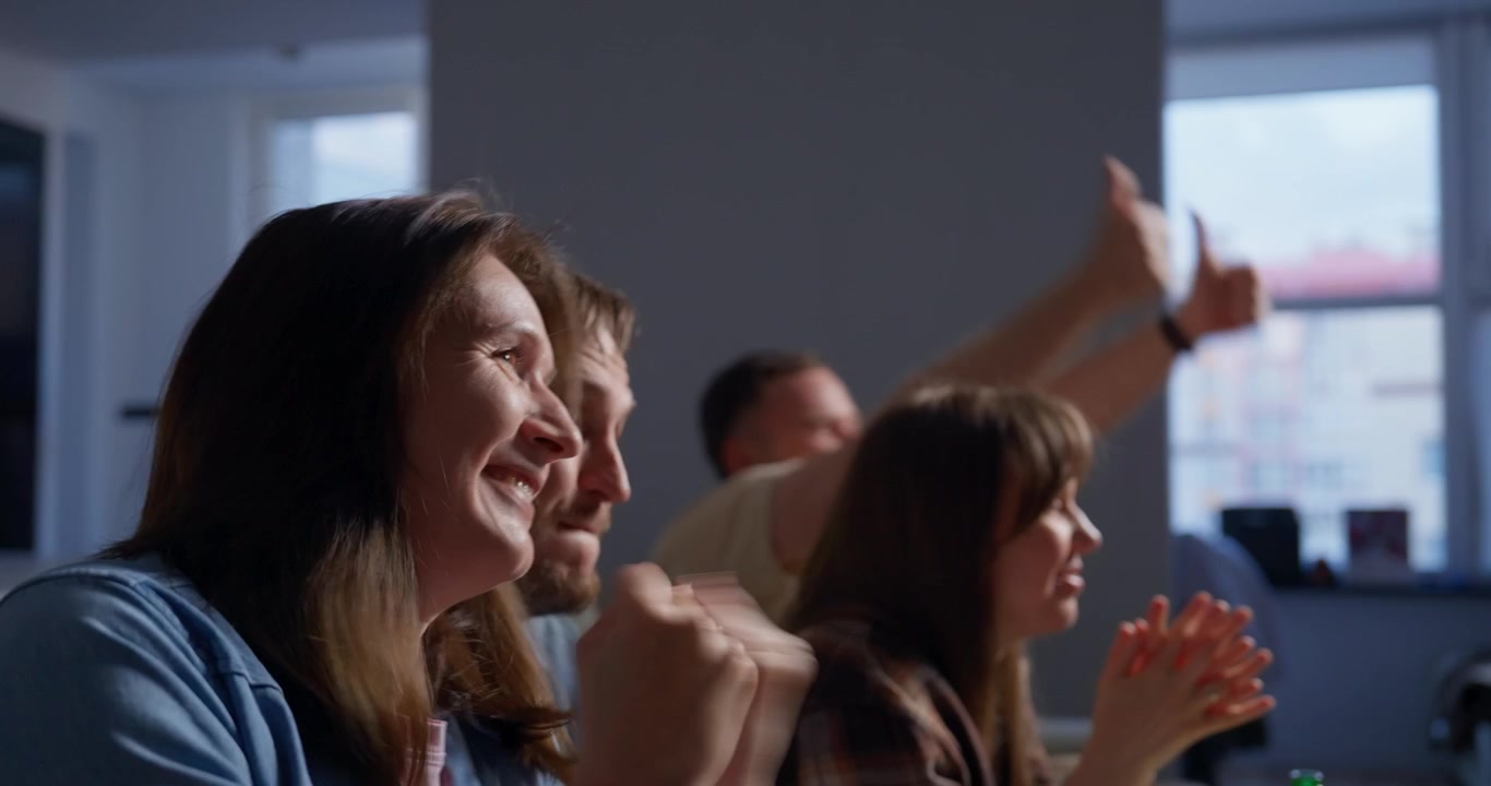 Excited Friends Watching TV and Cheering Together at Home