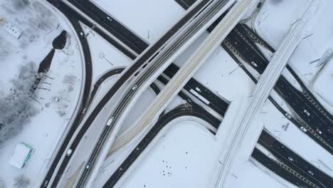 aerial view of a freeway intersection snow-covered in winter.