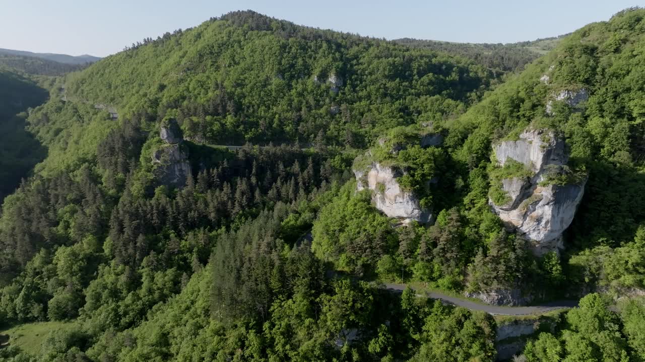 Imágenes aéreas de dron orbitando la formación rocosa de piedra caliza Sabot de Malepeyre. Estructura geológica única que se eleva desde un denso bosque verde en la región de las Gargantas del Tarn en Francia.