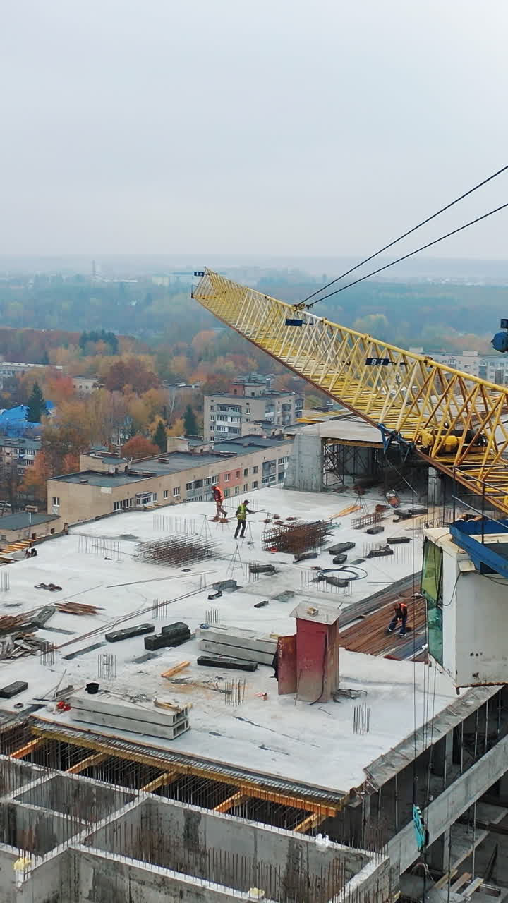 Aerial view of construction site in the city. Big crane and workers on ...