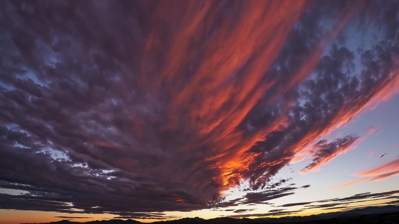 Dramatic sunset sky with vibrant clouds captured in a wide-angle view, ideal for a time-lapse video