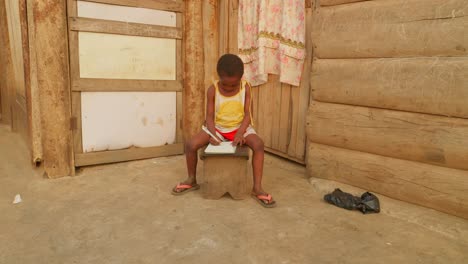 africa school education system, black children kid student , studying alone in rural remote poor undeveloped village taking note while sitting in a corner