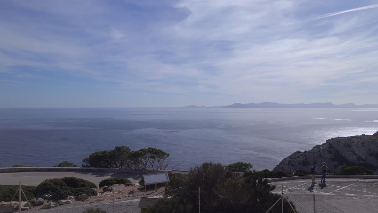 Experience breathtaking views from Cap Formentor Lighthouse, overlooking the shimmering Mediterranean Sea and stunning coastal landscapes of Mallorca during a clear day.