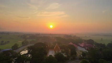 aerial drone clip over a temple in thailand during a stunning sunrise