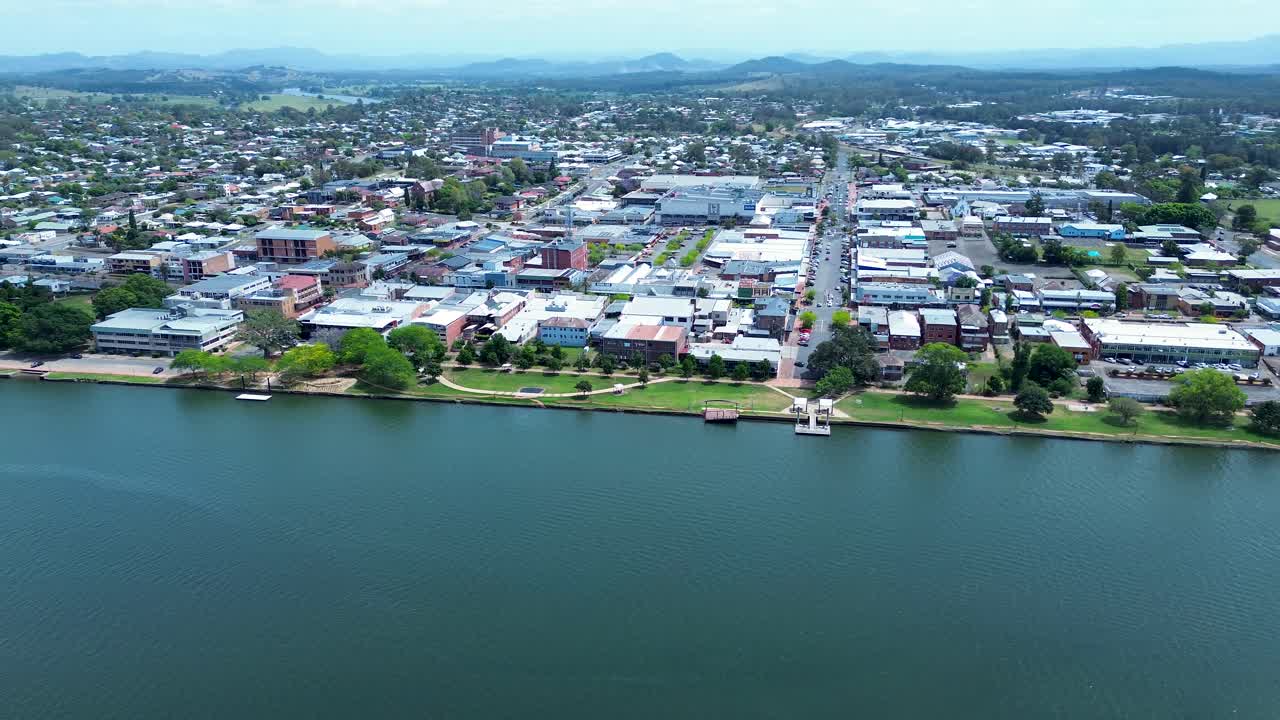 Drone aerial landscape of suburban town centre with waterfront foreshore park and commercial shop buildings along Manning River inlet in Taree Mid North Coast Australia travel tourism infrastructure