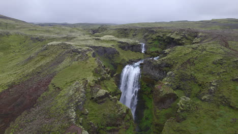 Aerial-high-above-the-famous-natural-landmark-and-tourist-attraction-of-Skogafoss-falls-and-Fimmvorduhals-trail-in-Iceland