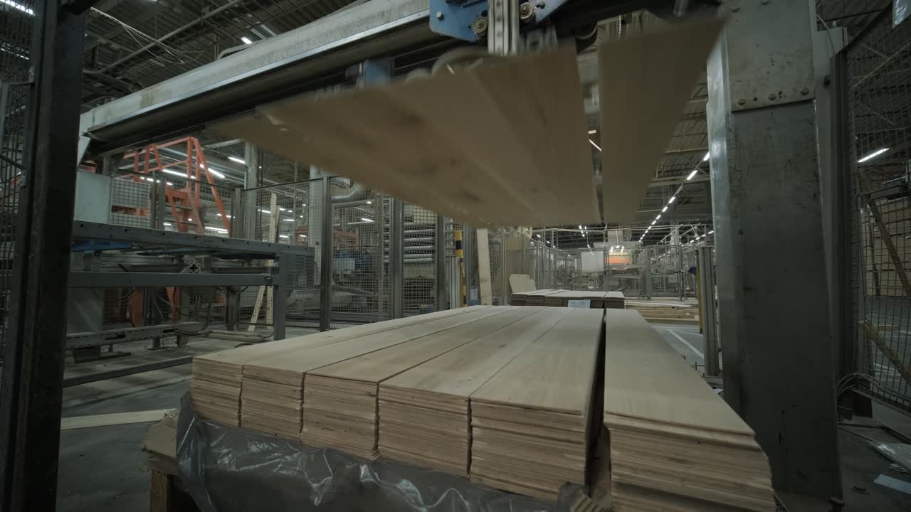 Automated Machine Stacking Wooden Planks in a Factory