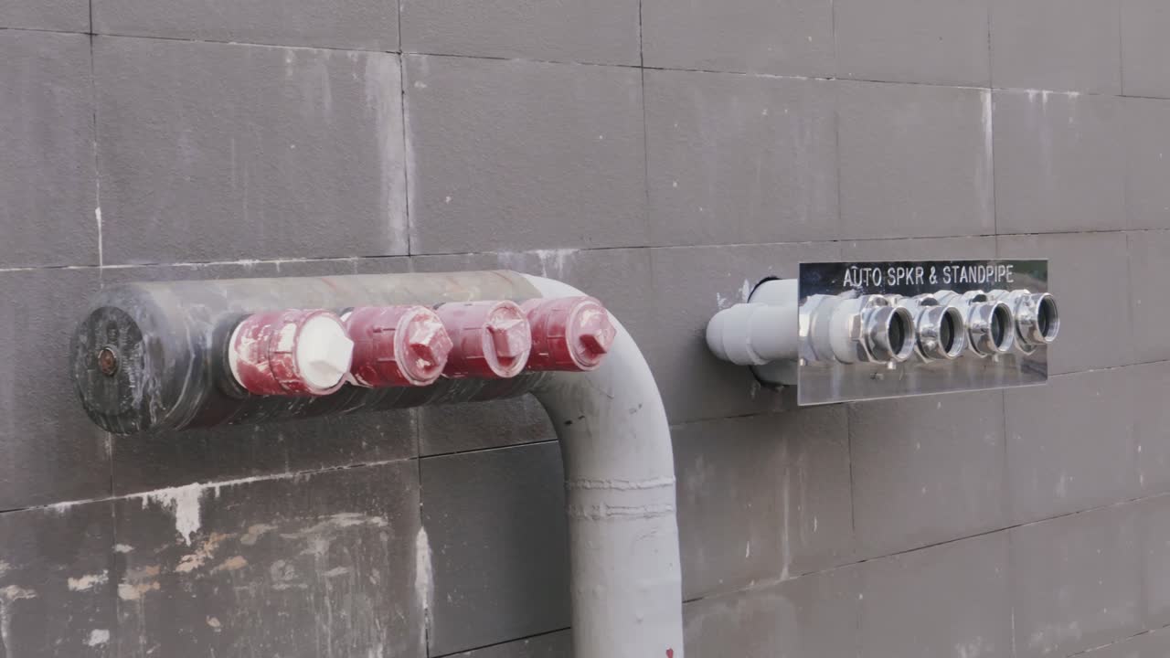 Pipeline behind a building with unfinished pipe