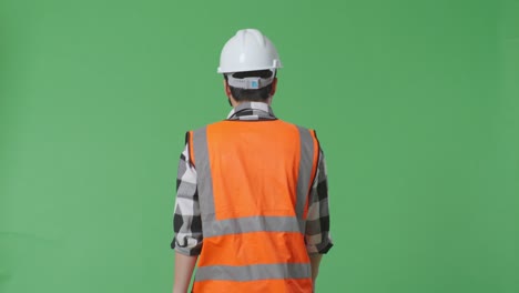 construction worker back view on green screen