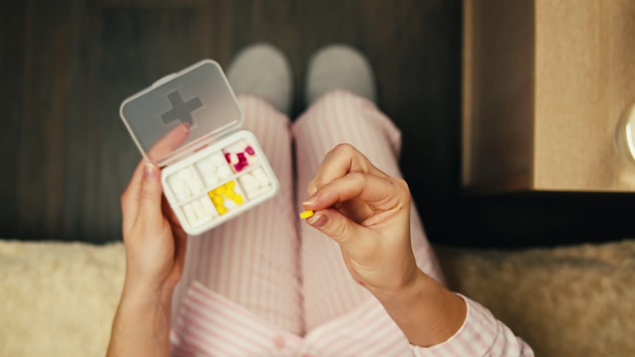 Woman Taking Medication in Pajamas