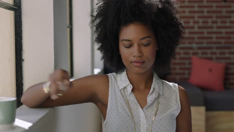 portrait young woman using smartphone drinking coffee at home enjoying relaxed morning browsing messages looking out window thinking contemplative