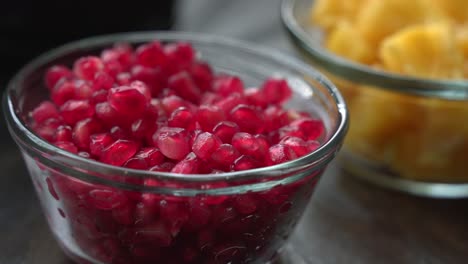 Nice-close-up-shot-of-juicy-red-pomegranate-seeds-inside-of-glass-cup-healthy-anti-oxidants-cardioprotective-properties