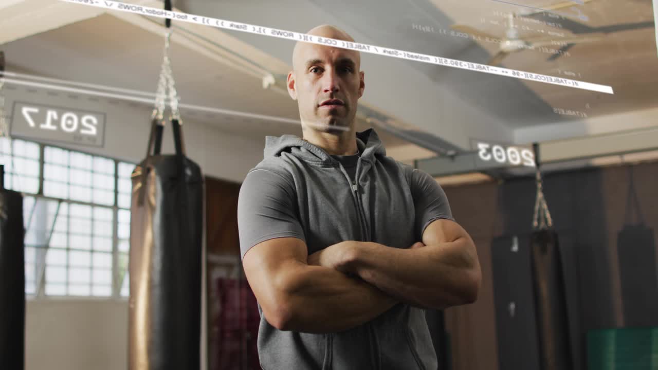 Trainer standing arms crossed in gym with bags HUD dates sliding over torso showing progress