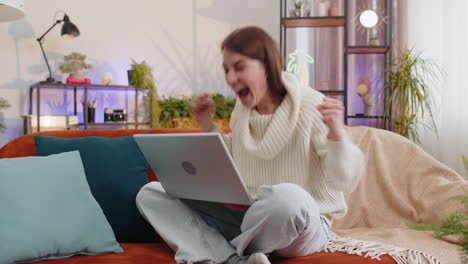 Amazed-young-woman-use-laptop-computer,-receive-good-news-message,-shocked-by-victory,-celebrate-win