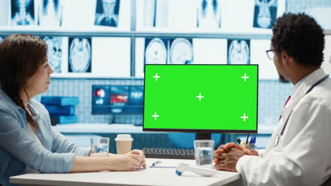 african american medical expert looking at copy space screen with a patient