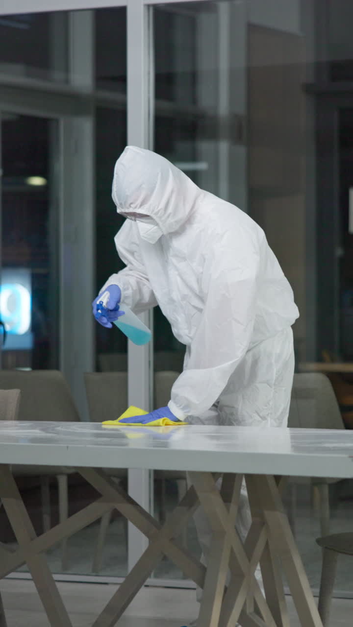 Disinfecting a surface with protective suit