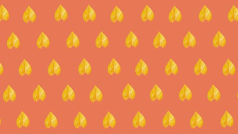animation of multiple yellow autumn leaves over orange background
