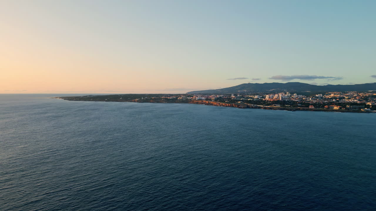 Serene sea evening seaside town. Picturesque aerial ocean coast with resort city