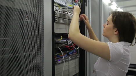 Woman-fixing-wires-and-smiling