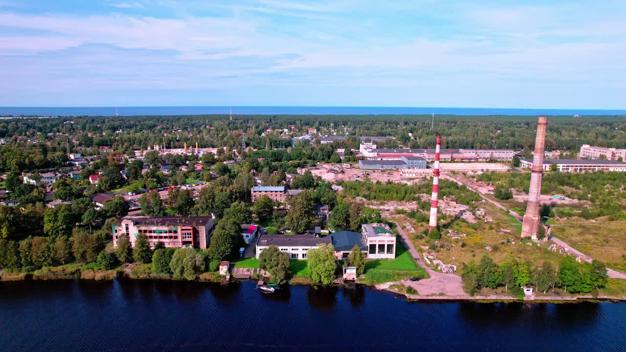 Aerial view of lush coastal Latvia with greenery and buildings
