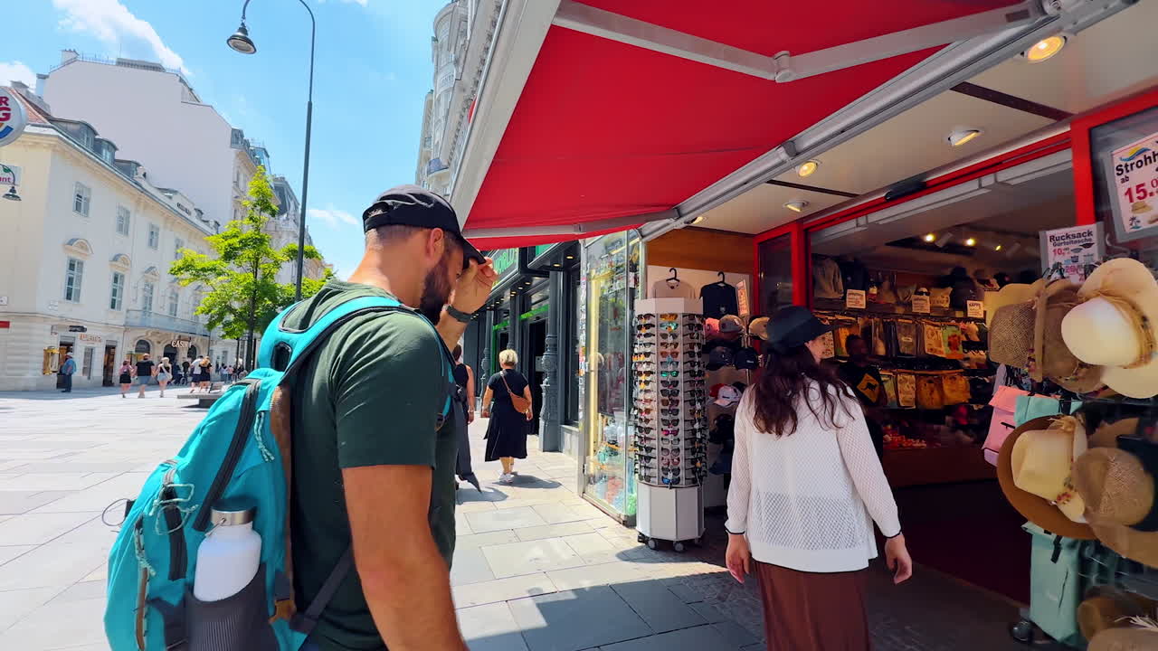 Vienna, Austria - June 9, 2025: People enter the gifts and souvenir shop with a range of things. Tour by the street of Vienna, Austria