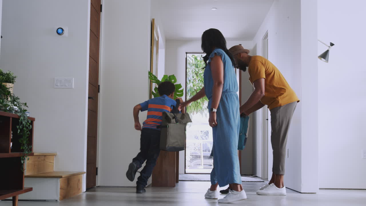Parents And Children Opening Front Door And Leaving Home Together