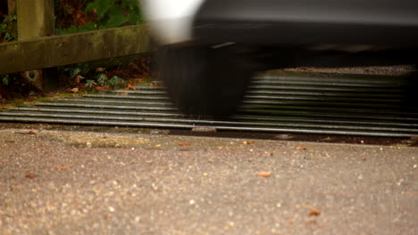 close up of a white car going over a cattle grid in the new forest