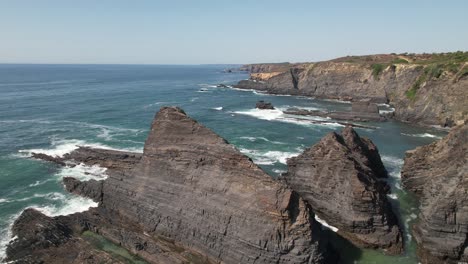 sunny day at beautiful beach with cliffs in costa vicentina, alentejo, portugal