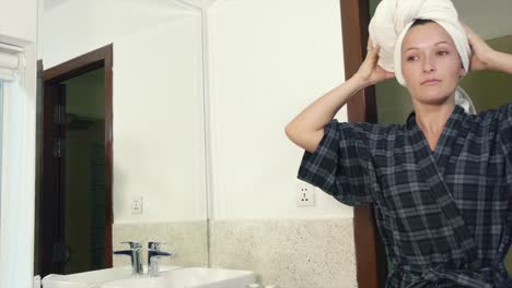 Young-Lady-Wrapping-a-Towel-Round-Her-Head-After-Showering-in-a-Hotel-Bathroom